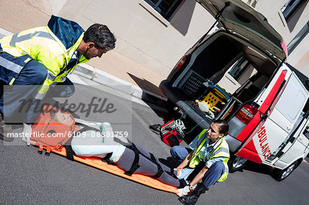 Ambulance men taking care of injured people