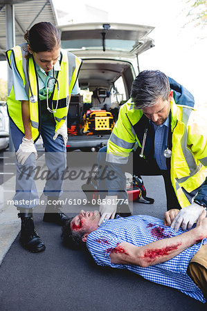 Ambulanceman healing injured man