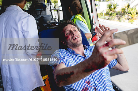 Injured man with ambulance men