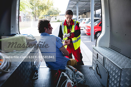 Injured man with ambulance woman