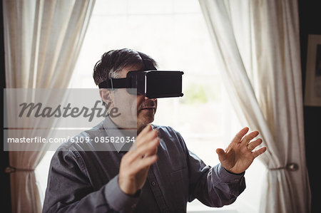 Mature casual man using smart glasses