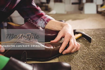 Close up of hands holding a shoe