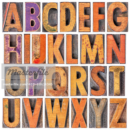 English alphabet in wood type - 26 isolated letters in letterpress printing blocks with a lot of character due to scratches and ink stain