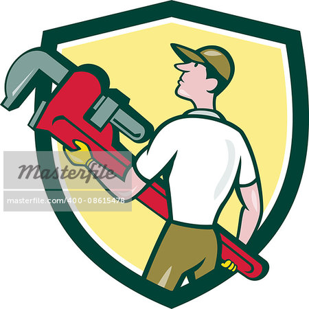 Illustration of a plumber wearing hat walking lifting giant monkey wrench looking to the side viewed from rear set inside shield crest on isolated background done in cartoon style.
