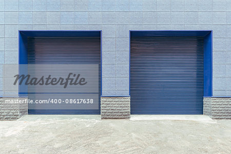 Metal blue gates of the shop storage.