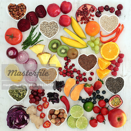 Paleolithic diet health and superfood of fruit, vegetables, nuts and seeds on distressed white wooden background, high in vitamins, anthocyanin, antioxidants, dietary fiber and minerals.