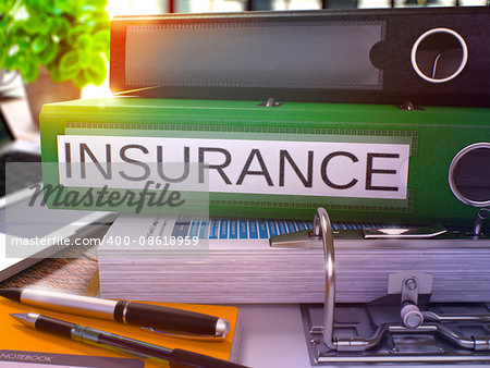 Insurance - Green Office Folder on Background of Working Table with Stationery and Laptop. Insurance Business Concept on Blurred Background. Insurance Toned Image. 3D.