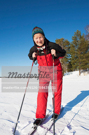 Sweden, Gastrikland, Ockelbo, Portrait of senior woman skiing