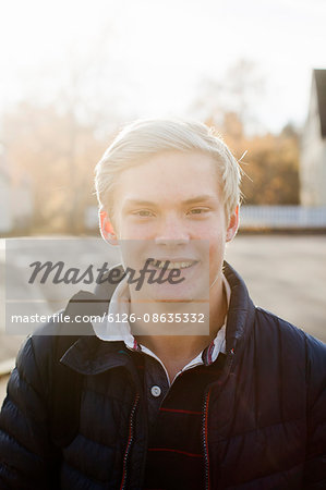 Sweden, Sodermanland, Strangnas, Portrait of teenage boy (16-17) standing on sidewalk