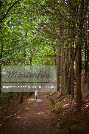 Sweden, Skane, Kockenhus, Girl (6-7) walking in forest