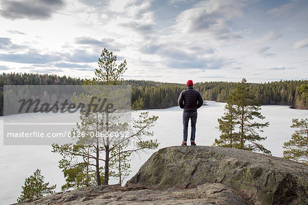 Sweden, Narke, Kilsbergen, Mature hiker looking at forest