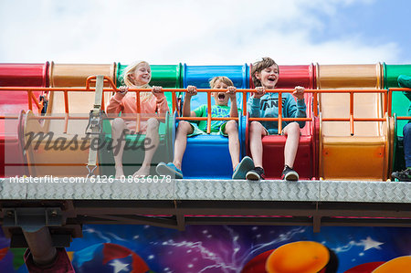 Sweden, Skane, Simrishamn, Excited children (10-11, 12-13) in amusement park