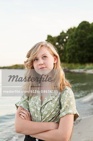 Sweden, Blekinge, Hallevik, Portrait of teenage girl (16-17) standing on beach