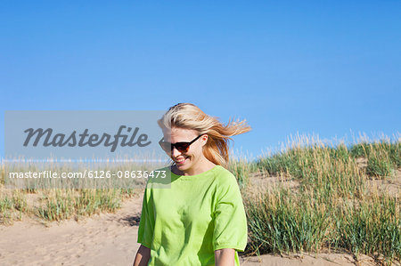 Finland, Pori, Yyteri, Smiling woman on beach at sunny day