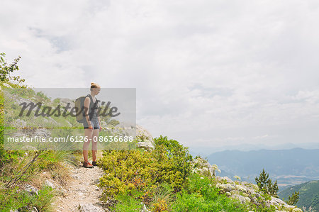 France, Pelleautier, Ceuse, Woman standing on hiking path on mountain side