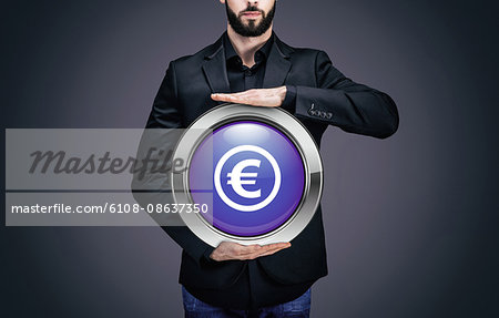 Businessman holding a circle containing the symbol "Euro"