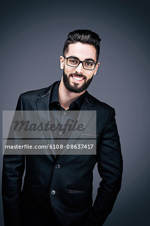 Portrait of a smiling young businessman, looking toward the lens