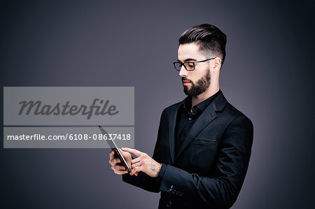 Portrait of a young businessman holding a touch pad in his hands