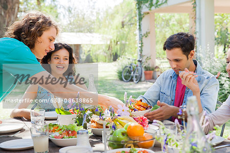 Friends having meal together outdoors