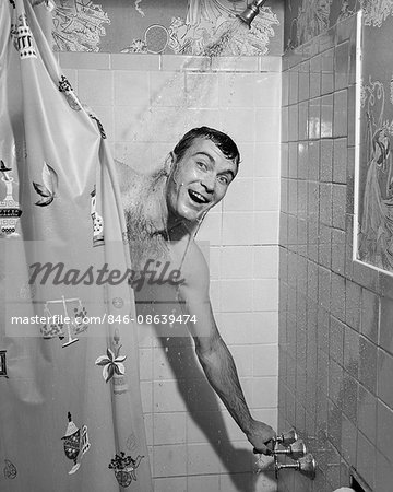 1950s MAN IN SHOWER TURNING ON WATERAND PULLING SHOWER CURTAIN CLOSED 1950s MAN IN SHOWER TURNING ON WATERAND PULLING SHOWER CURTAIN CLOSED