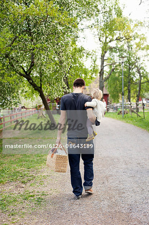 Sweden, Uppland, Father walking with daughter (18-23 months)