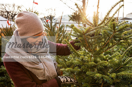 Sweden, Stockholm, Gamla Stan, Woman choosing christmas tree