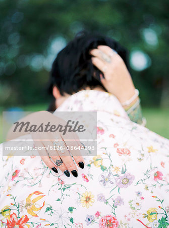 Sweden, Bride and groom in shirt with floral pattern at hippie wedding