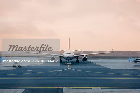 Germany, Frankfurt, Airplane on runway at dusk