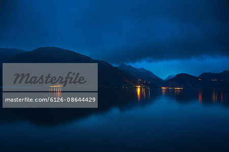 Norway, More og Romsdal, Sunnmore, View of lake in mountains at dusk