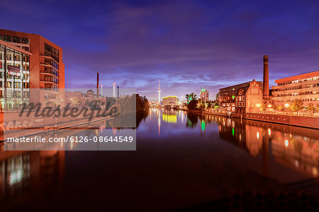 Germany, Berlin, Kreuzberg, Illuminated buildings reflecting in river