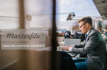 Finland, Helsinki, Businessman at outdoor cafe