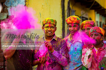 Men throwing colored pigment, Holi Festival, Vrindavan, Uttar Pradesh, India, Asia