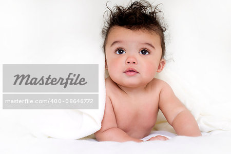 adorable baby boy wrapped with blanked on white background