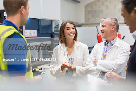 Smiling engineers and managers in steel factory