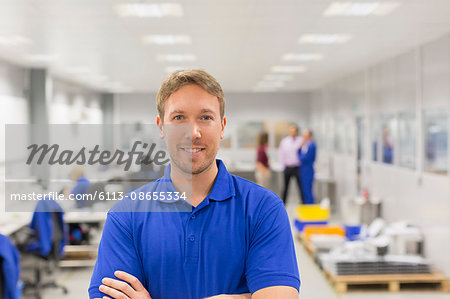 Portrait smiling worker in steel factory office