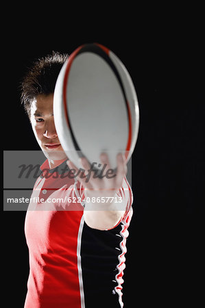 Portrait of Japanese rugby player with ball