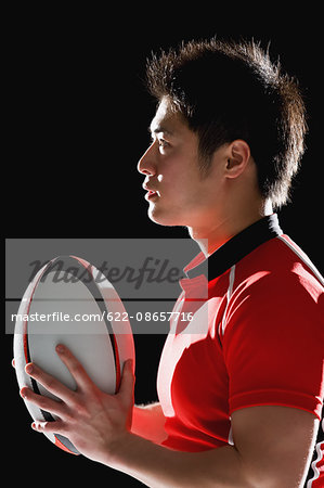 Portrait of Japanese rugby player with ball