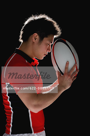 Portrait of Japanese rugby player with ball