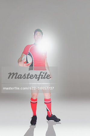 Portrait of Japanese rugby player with ball