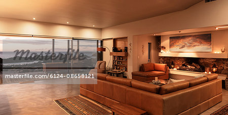 Home showcase interior living room overlooking ocean at sunset Home showcase interior living room overlooking ocean at sunset