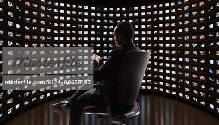 Man watching video on monitors