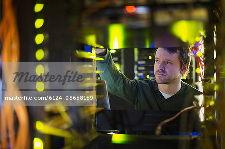 Server room technician working on server panel