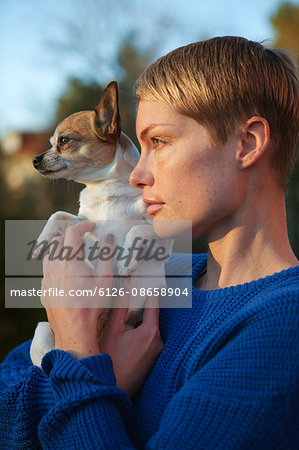 Sweden, Sodermanland, Stockholm County, Nacka, Mid adult woman holding dog