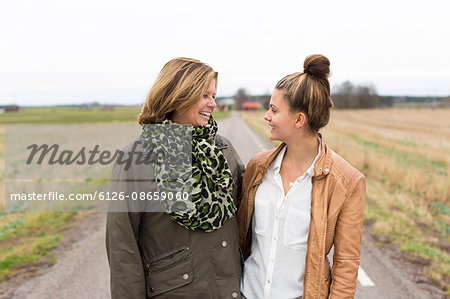 Sweden, Ostergotland, Mjolby, Mother and daughter (14-15) standing face to face