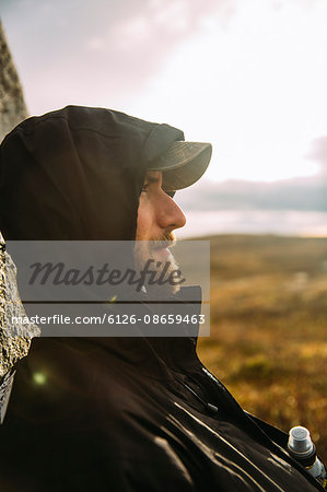 Sweden, Sylama, Jamtland, Portrait of young man in baseball cap and hood