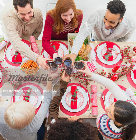 Friends toasting wine glasses at Christmas table