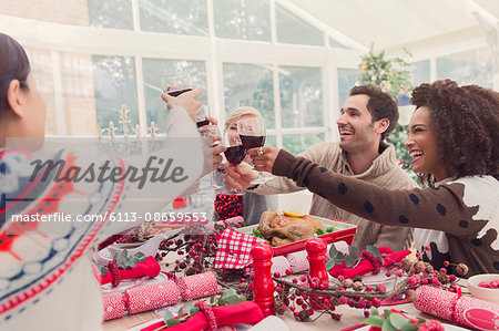 Friends toasting wine glasses at Christmas table