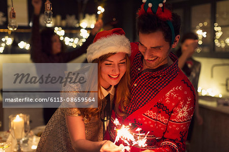 Playful couple with Christmas sparklers