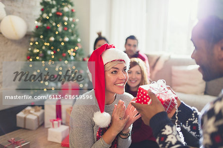 Boyfriend giving excited girlfriend Christmas gift