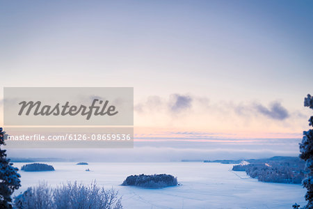 Finland, Pirkanmaa, Tampere, Landscape with frozen lake at dusk